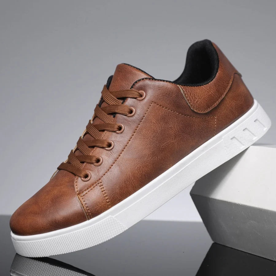 Men's lace-up trainers with textured white rubber sole and black synthetic upper construction