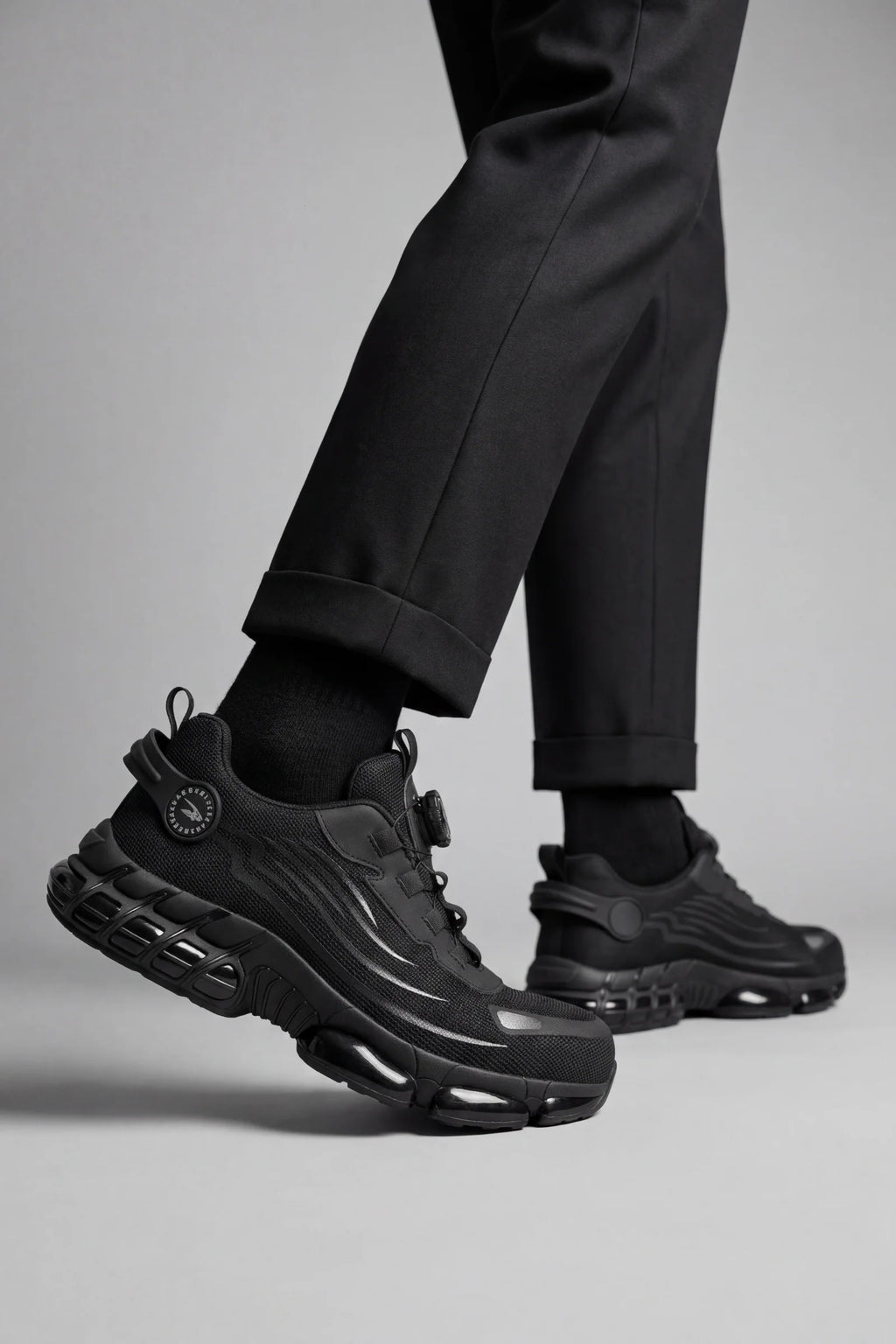 Side view of men's protective trainers with breathable mesh upper and reinforced toe cap