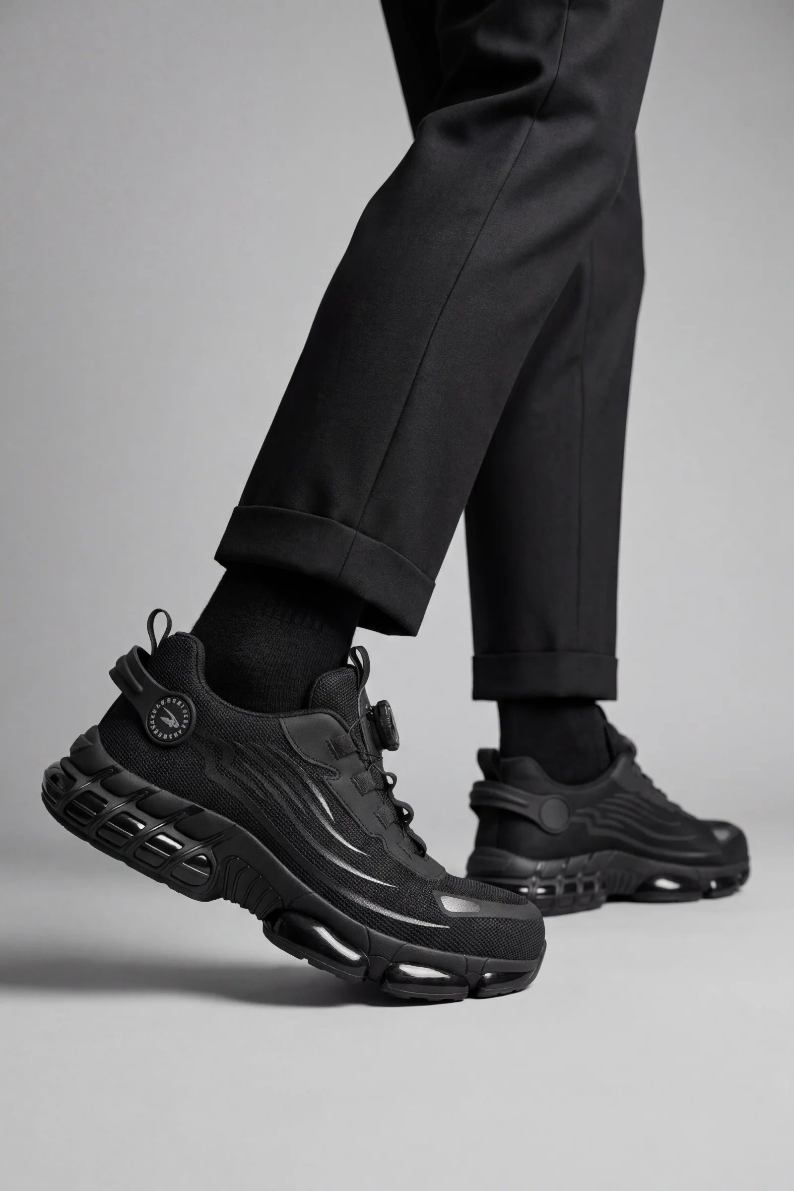 Side view of men's protective trainers with breathable mesh upper and reinforced toe cap