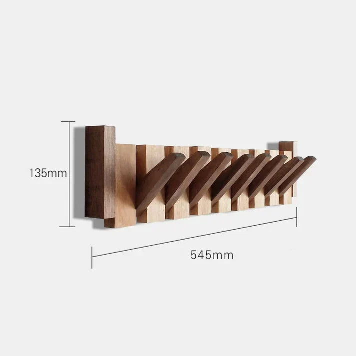 Detail shot of wall-mounted coat rack showing piano key hook configuration in beech and walnut