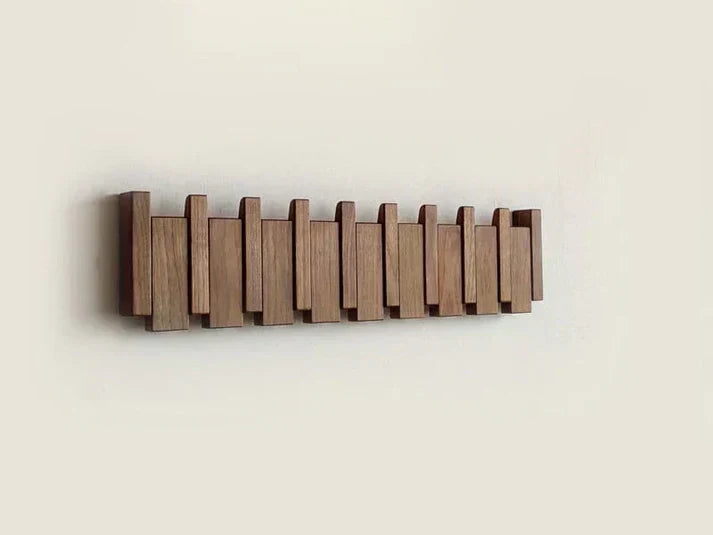 Wall-mounted wooden storage rack with piano design featuring multiple hooks for coats and accessories
