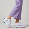 Women's canvas platform trainers in white with chunky sole and lace-up closure worn with lilac trousers
