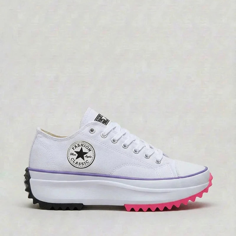 Close-up of women's white canvas platform trainers showing chunky sole and lace-up detail