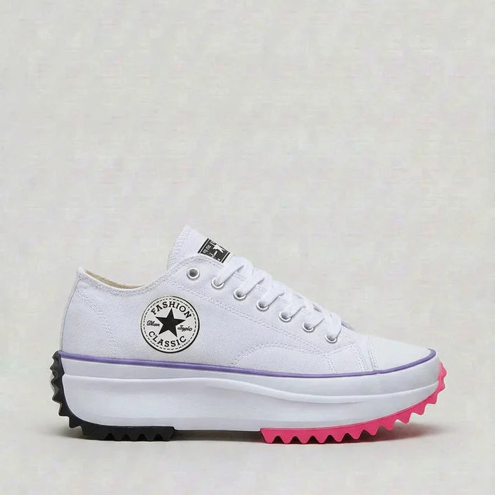 Close-up of women's white canvas platform trainers showing chunky sole and lace-up detail
