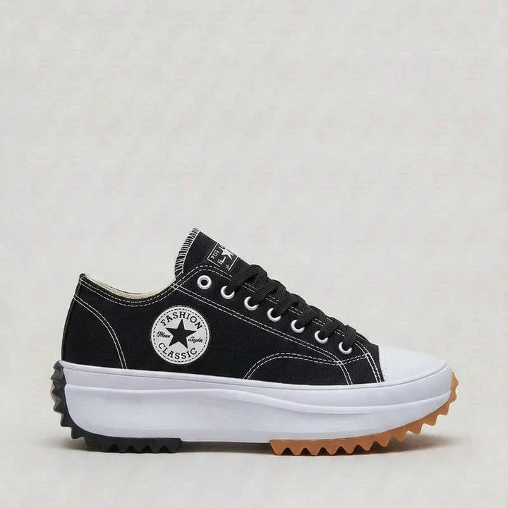 Women's canvas platform trainers in white displaying thick platform sole and secure lacing
