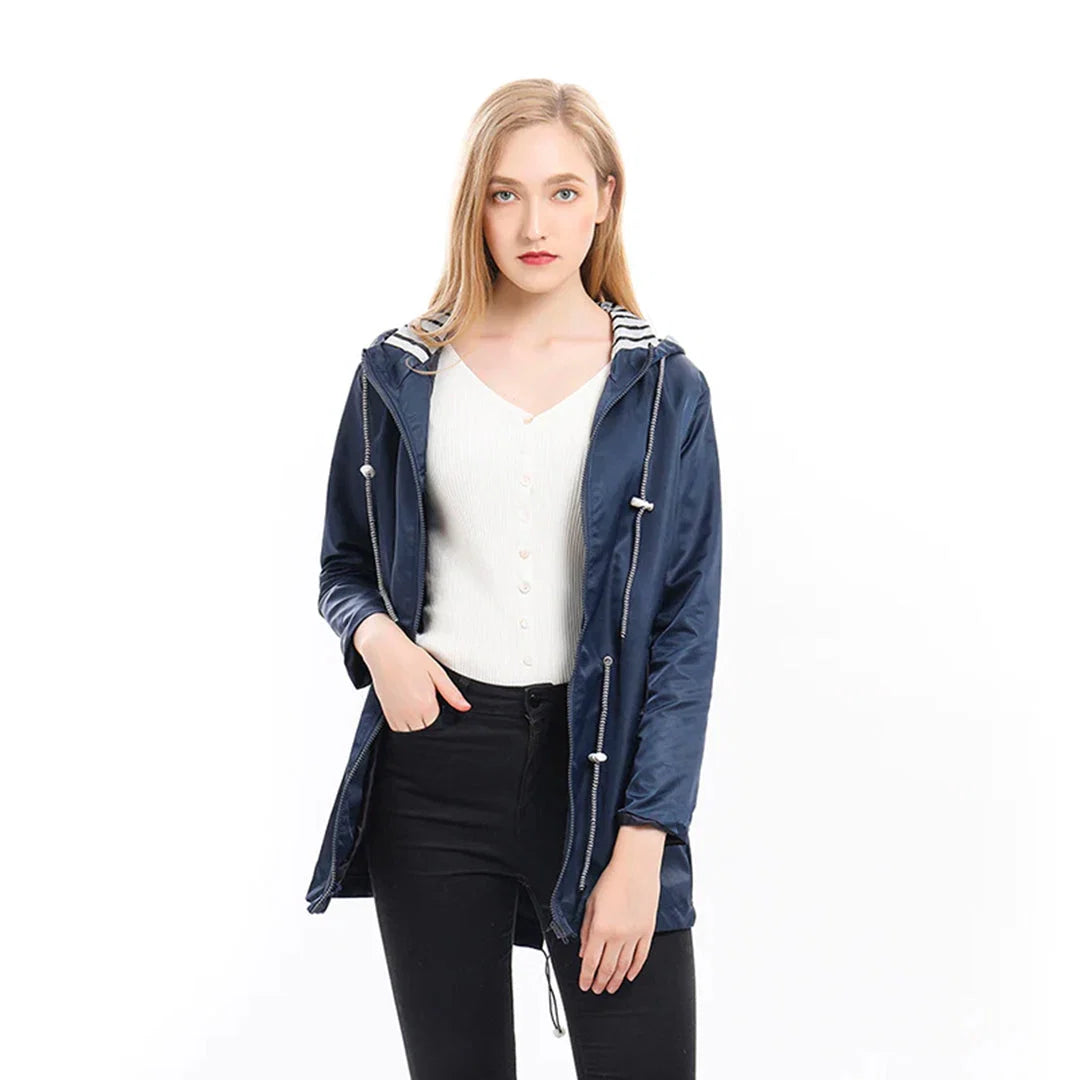 Hooded raincoat worn showing relaxed silhouette and practical design features