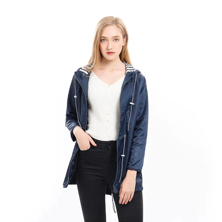 Hooded raincoat worn showing relaxed silhouette and practical design features