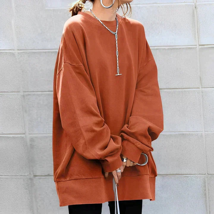 Detail shot of women's oversized sweatshirt highlighting crew neck and soft fabric drape