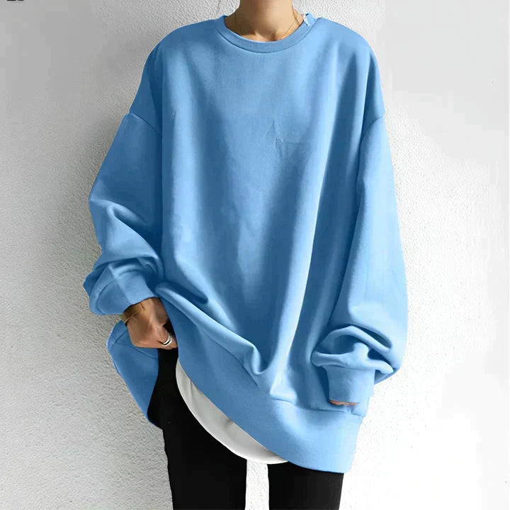 Full view of women's oversized sweatshirt styled with black trousers for casual layered look