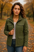 Women's utility jacket in olive green with stand collar, zip and button front closure, multiple pockets.