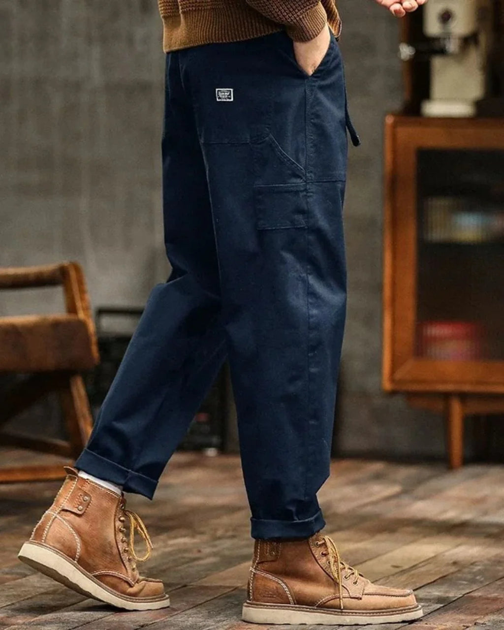 Men's cargo trousers in khaki worn casually with rolled hems and lace-up boots