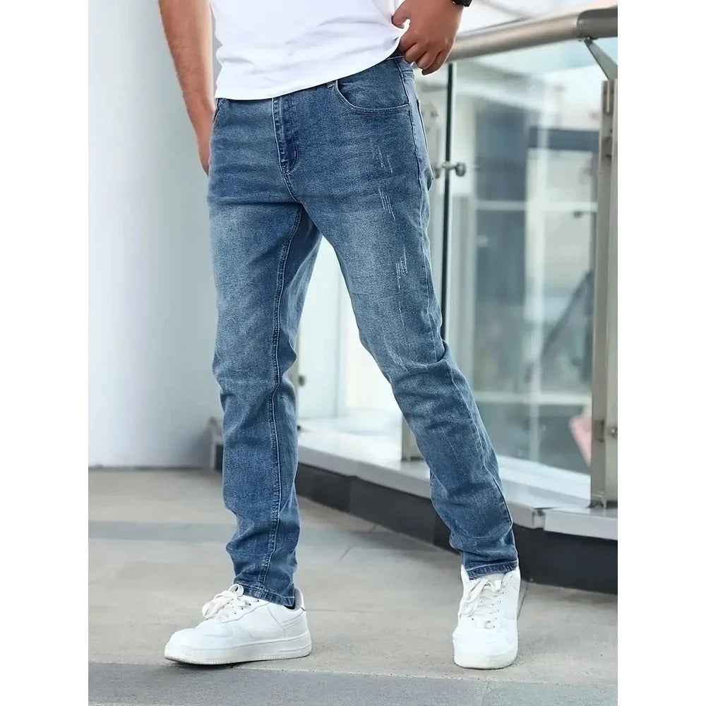 Close-up view of men's slim fit jeans showing classic five-pocket construction and contrast stitching detail