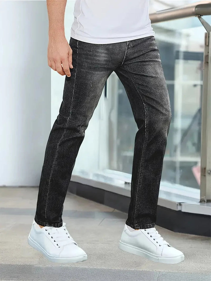 Men's slim fit jeans featuring zip fly closure, belt loops, and structured denim fabric