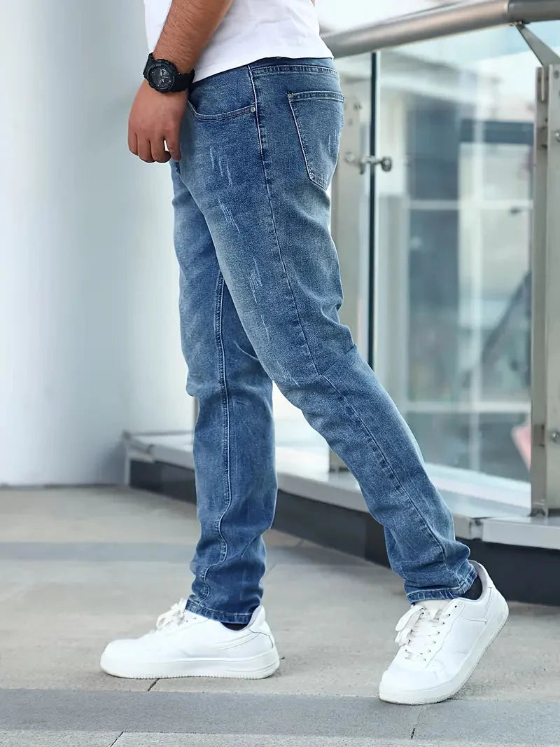 Rear view of men's jeans showing back pockets with contrast stitching and slim fit silhouette