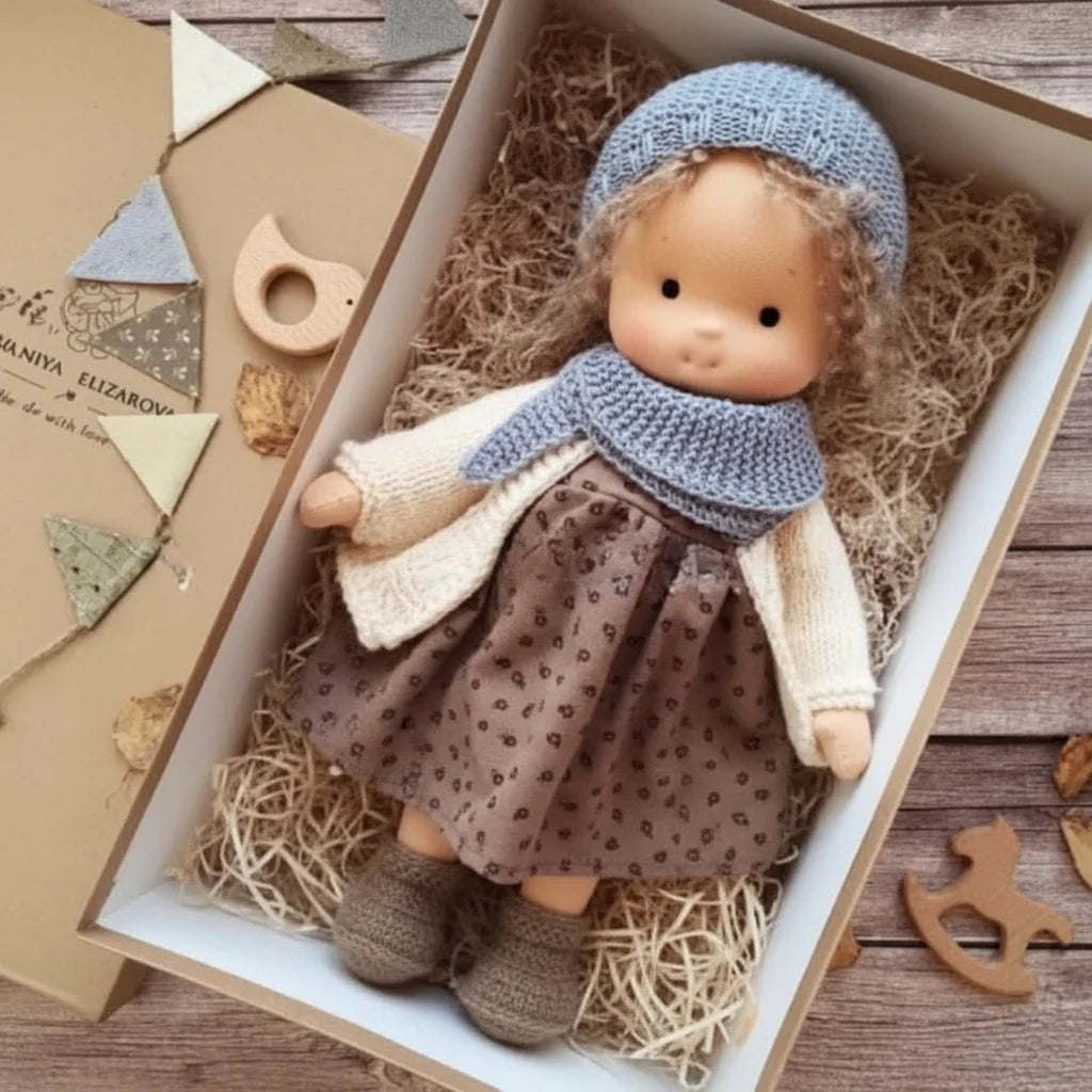 Waldorf-inspired doll with soft cotton construction and delicate knitted accessories