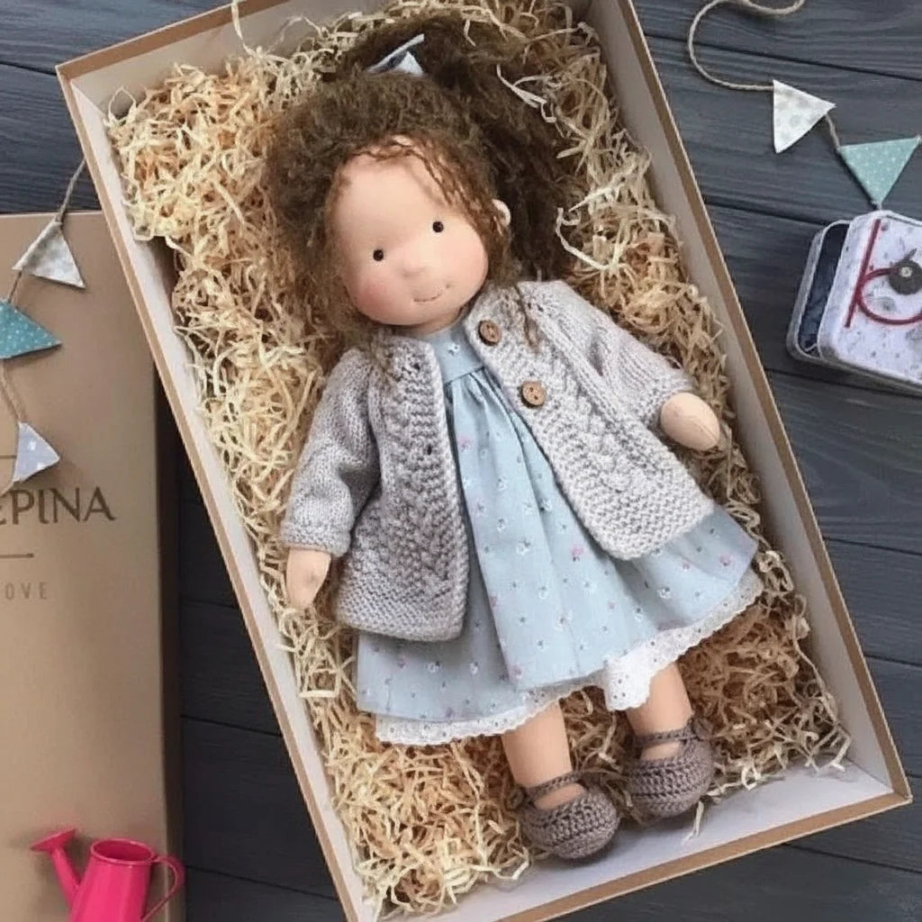 Minimalist cloth doll wearing bonnet, cardigan and dress for creative storytelling play