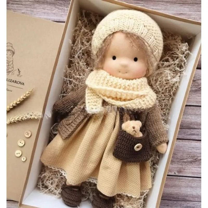 Handcrafted cloth doll in coordinating cream and lilac knitted outfit with lace details