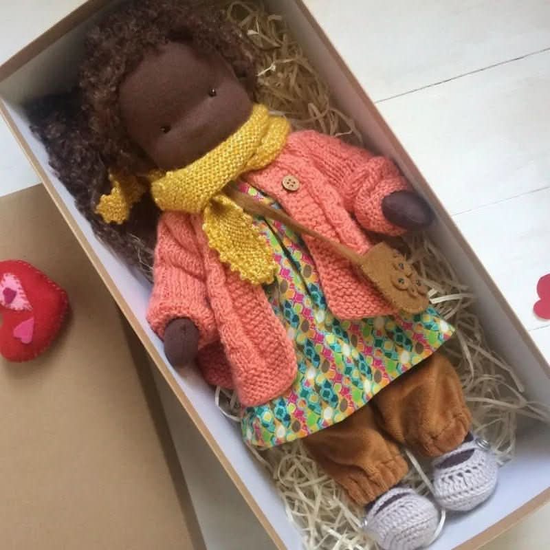 Waldorf-style doll dressed in coordinating outfit with lace-trimmed dress and booties