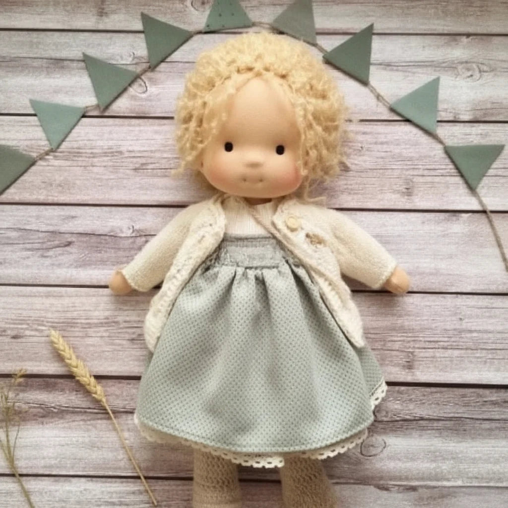 Waldorf-style doll with blonde hair and knitted accessories for role-playing activities
