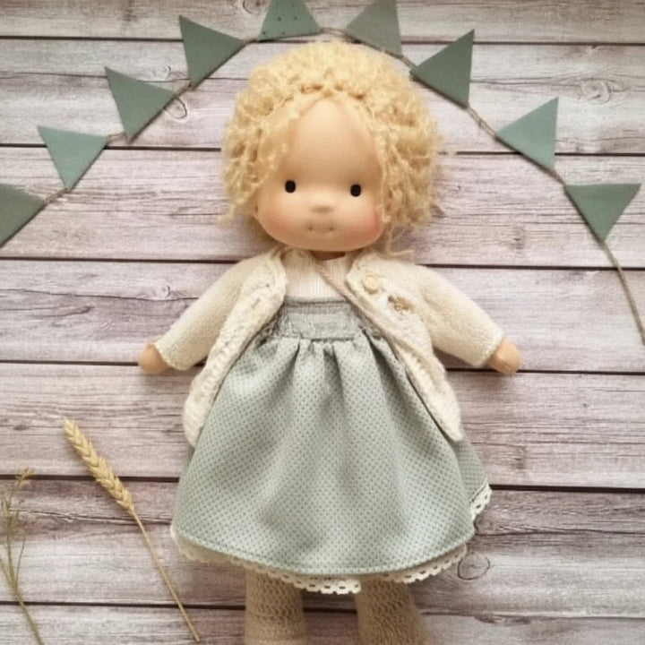 Waldorf-style doll with blonde hair and knitted accessories for role-playing activities