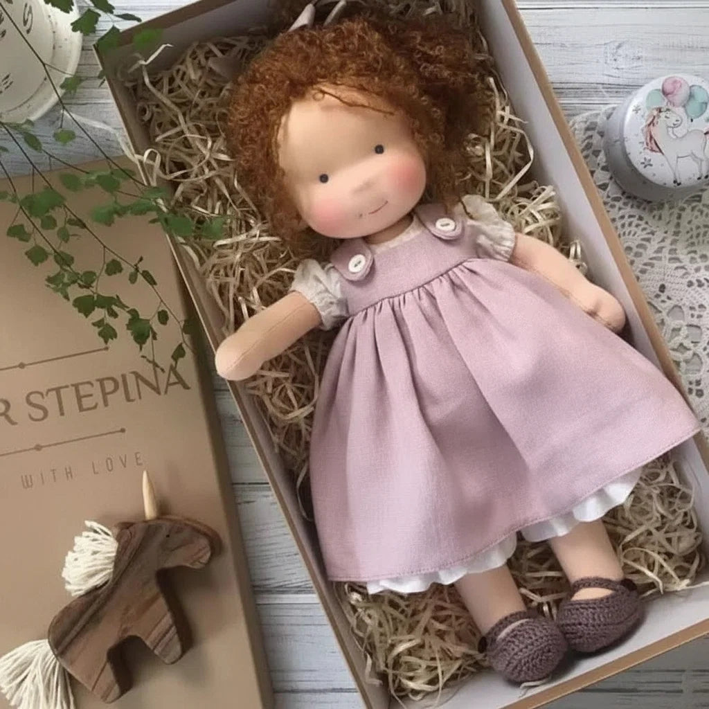 Cloth doll in gift presentation box showing cream and lilac colour palette