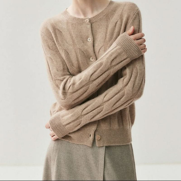 Close-up view of cable knit texture and button detail on women's cardigan