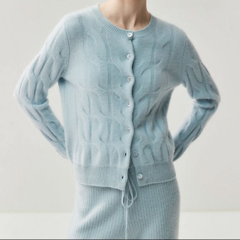 Detail of ribbed cuffs and hem on women's cable knit cardigan