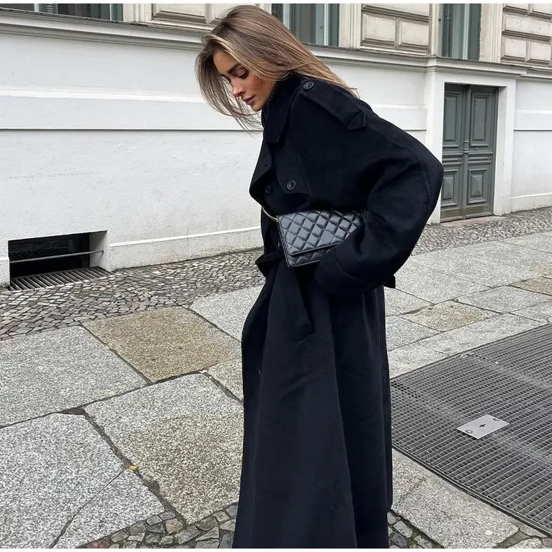 Black double-breasted trench coat with military epaulettes and structured collar detail