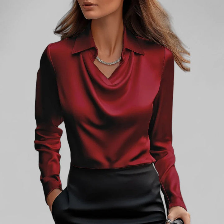 Detail shot of structured collar and smooth satin-finish fabric on draped blouse