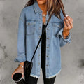 Woman wearing oversized denim shacket with frayed hem and chest pockets over black top