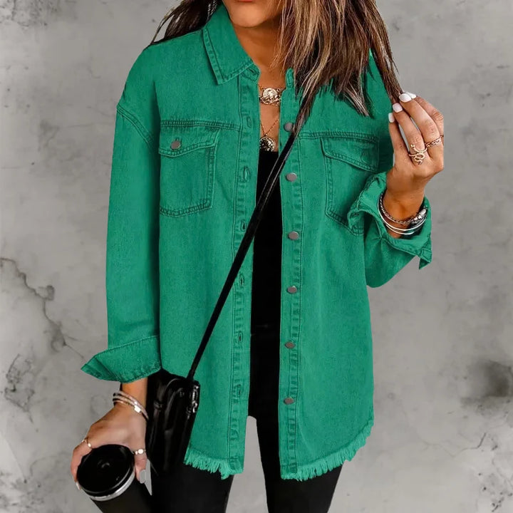 Woman styling oversized denim shacket for casual daywear with relaxed layered outfit