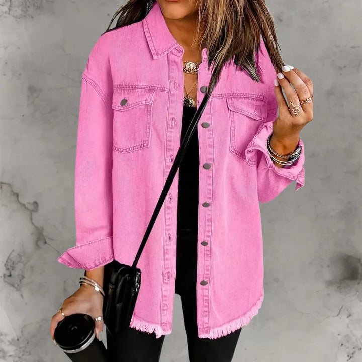 Close-up view of oversized denim shacket showing frayed raw hem detail and button-front closure