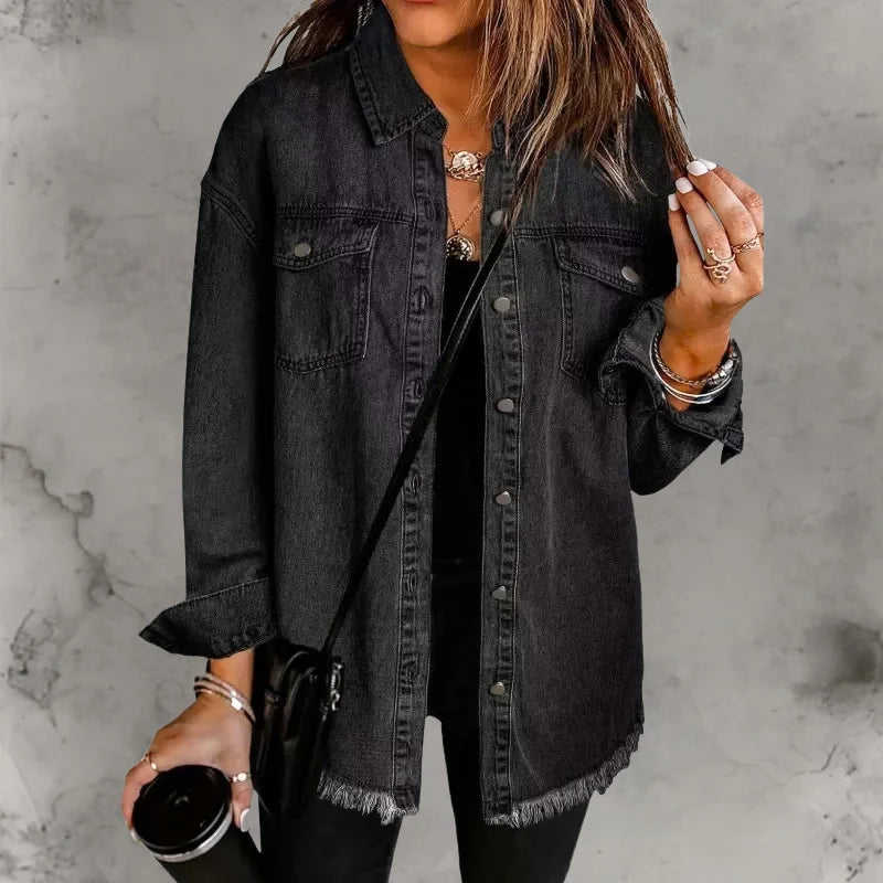Detail shot of denim shacket chest pockets with button-flap closures and collar styling