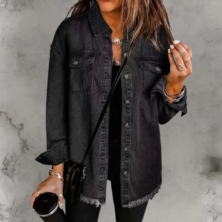 Detail shot of denim shacket chest pockets with button-flap closures and collar styling