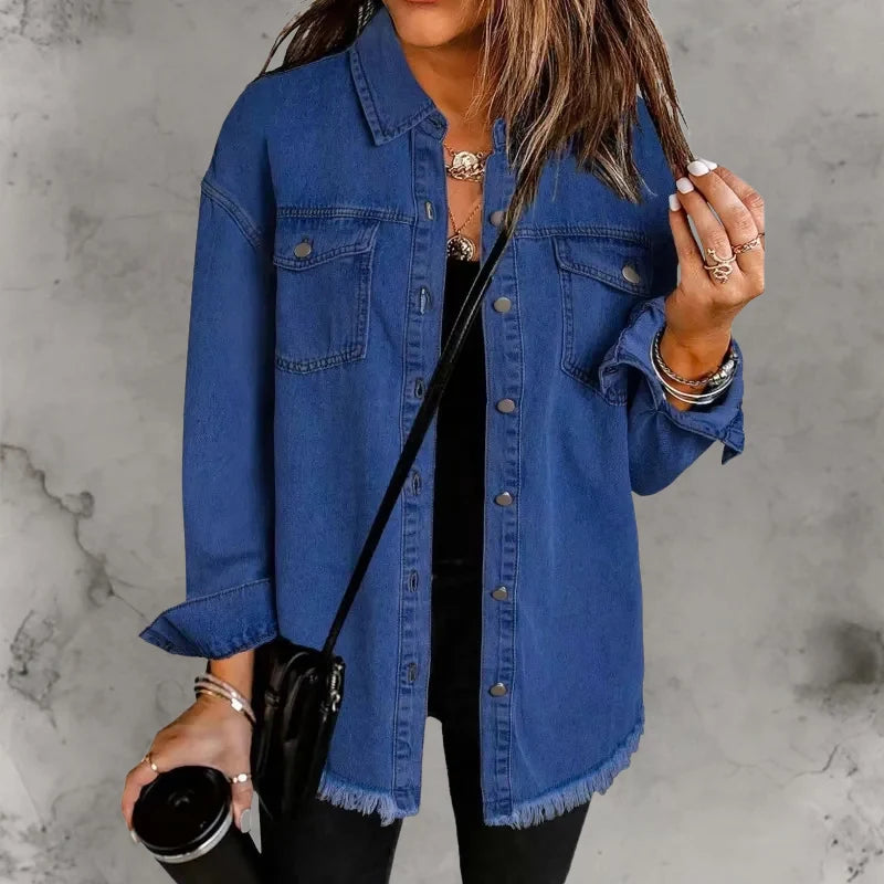 Woman styling oversized denim shacket open over black fitted top with casual layered look