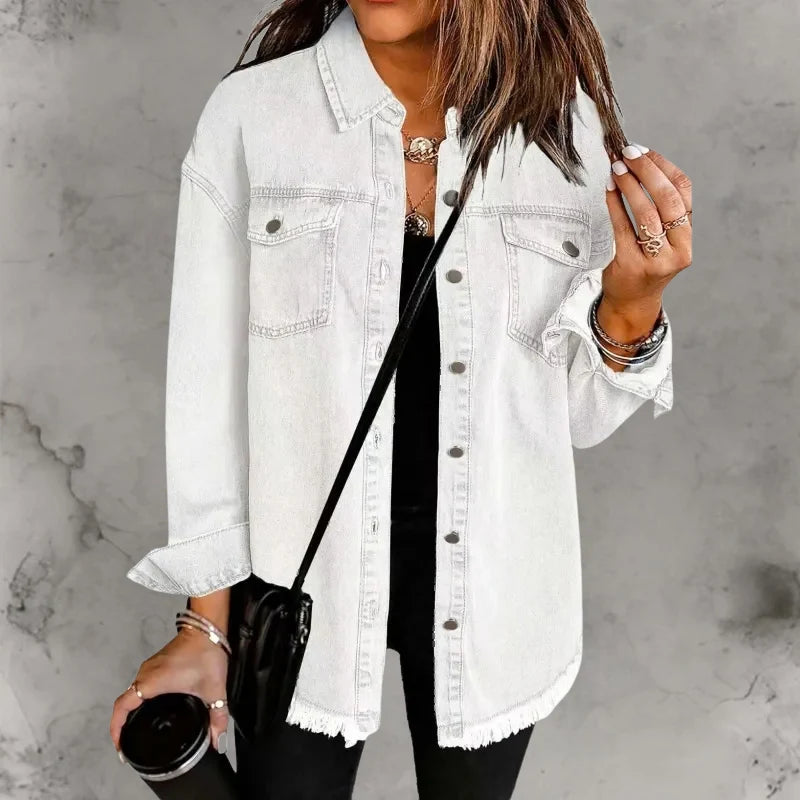 Close-up of denim shacket sleeve cuff with button closure and frayed hem detail
