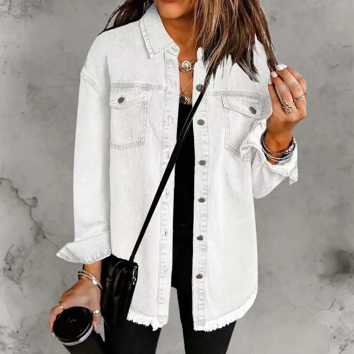 Close-up of denim shacket sleeve cuff with button closure and frayed hem detail