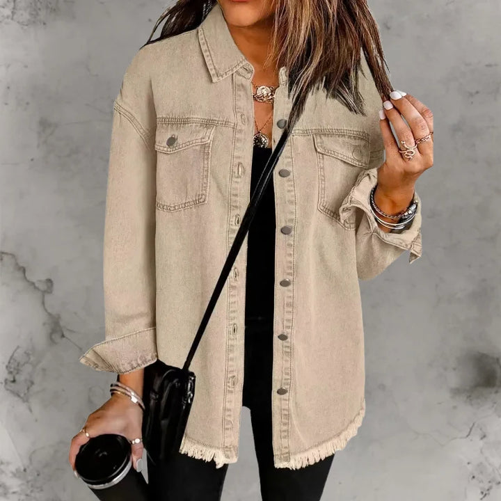 Front view of women's oversized denim shacket showing button-front and chest pocket placement