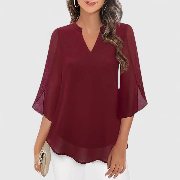 Pink blouse with flared sleeves and curved hem for versatile styling
