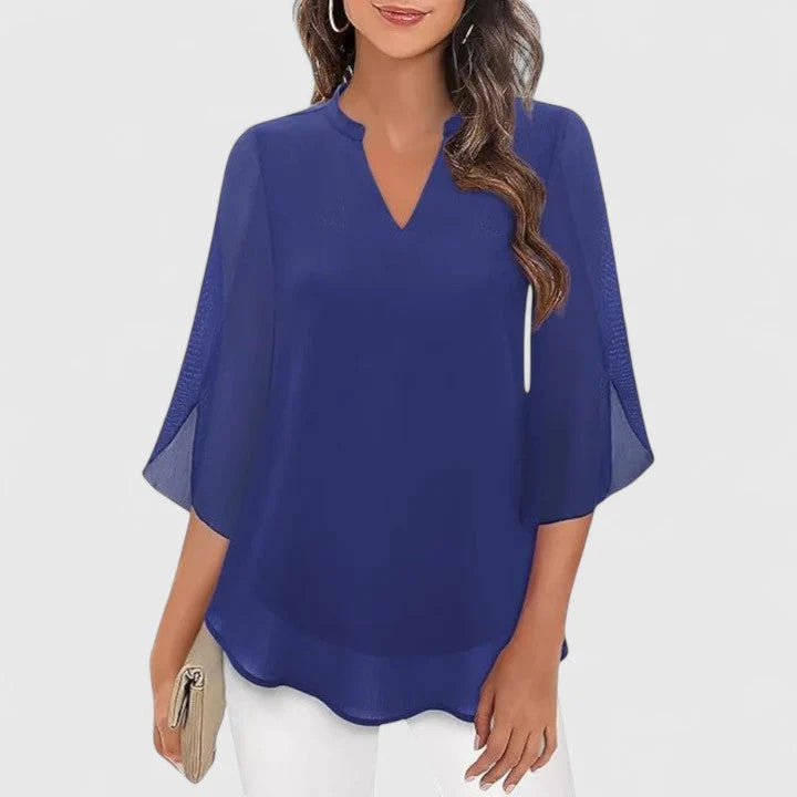 Purple V-neck blouse featuring lace inserts and flowing silhouette