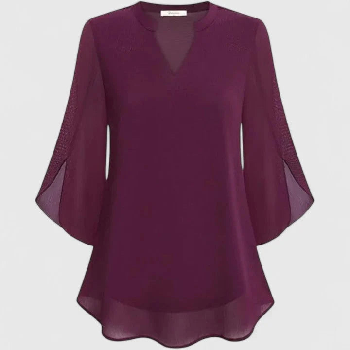Close-up of V-neckline and sheer lace sleeve panels on women's blouse