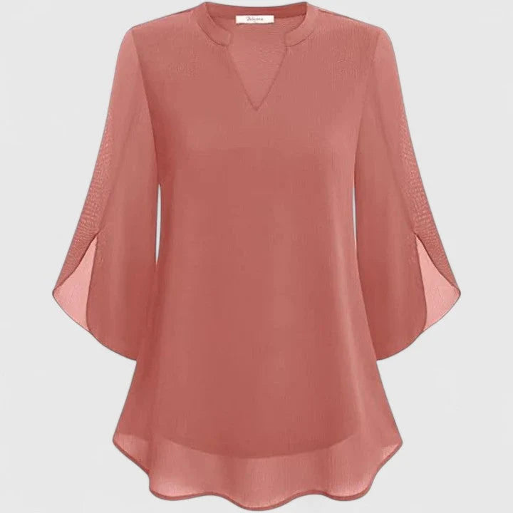 Side view of relaxed fit blouse with flared sleeves and curved hemline