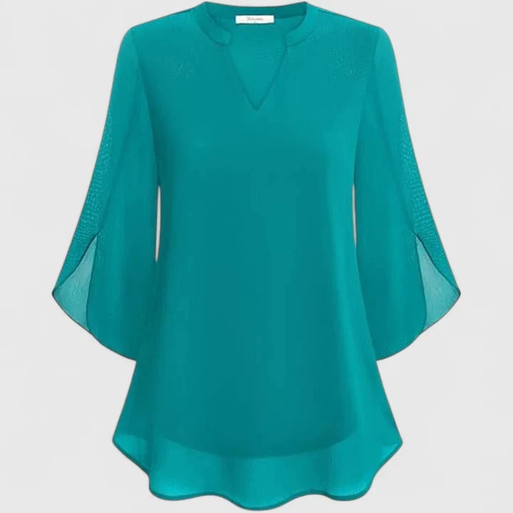 Back view showing concealed button closure and flowing blouse silhouette