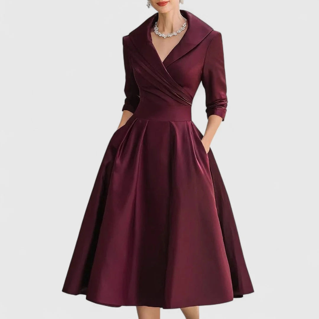 Side view of wrap bodice midi dress showing fitted waist and full pleated skirt silhouette