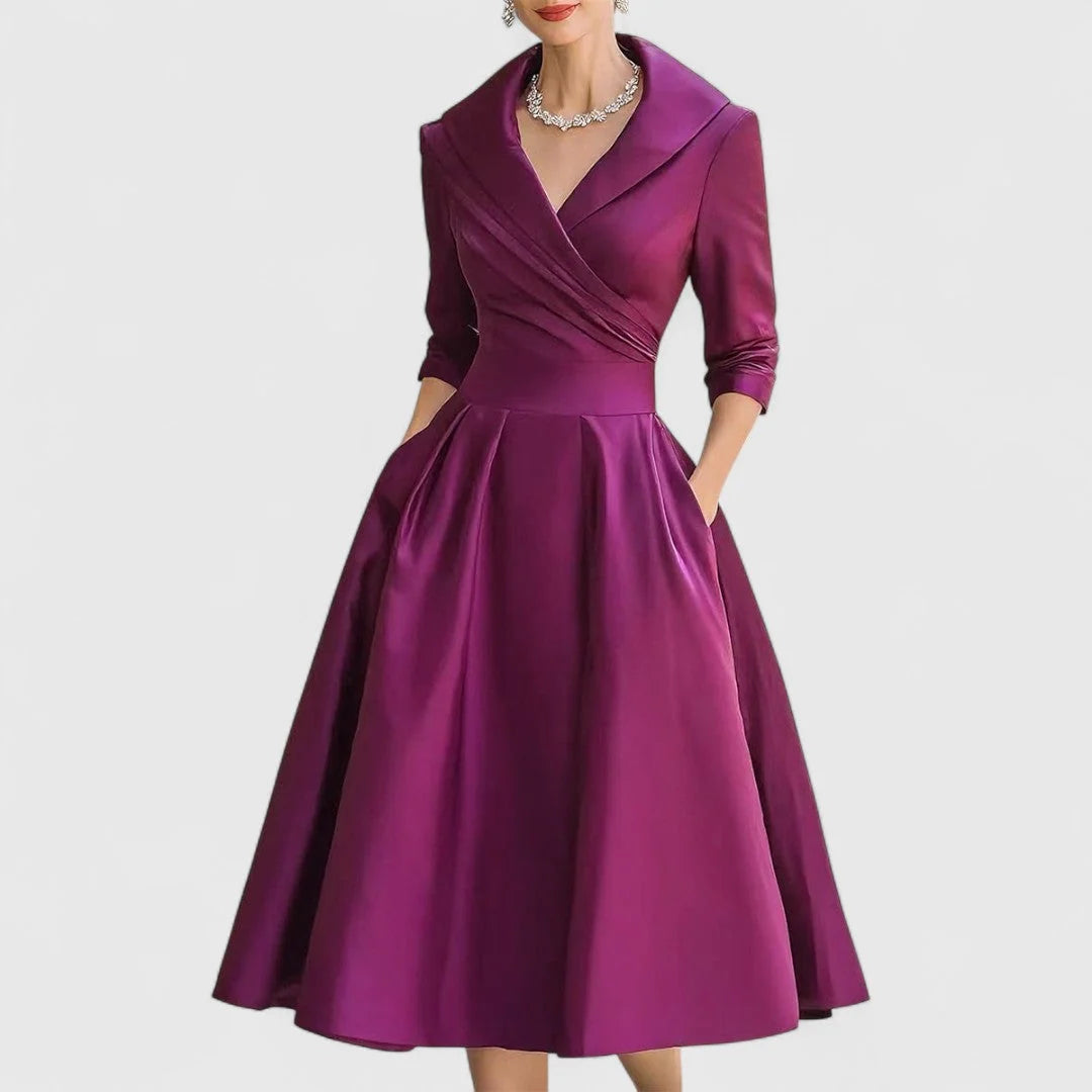 Back view of wrap bodice midi dress displaying full pleated skirt and tailored fit