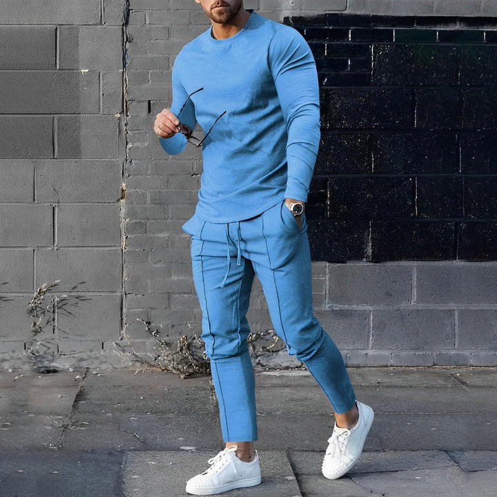 Side angle of men's two-piece set highlighting tapered trousers and long-sleeve top silhouette