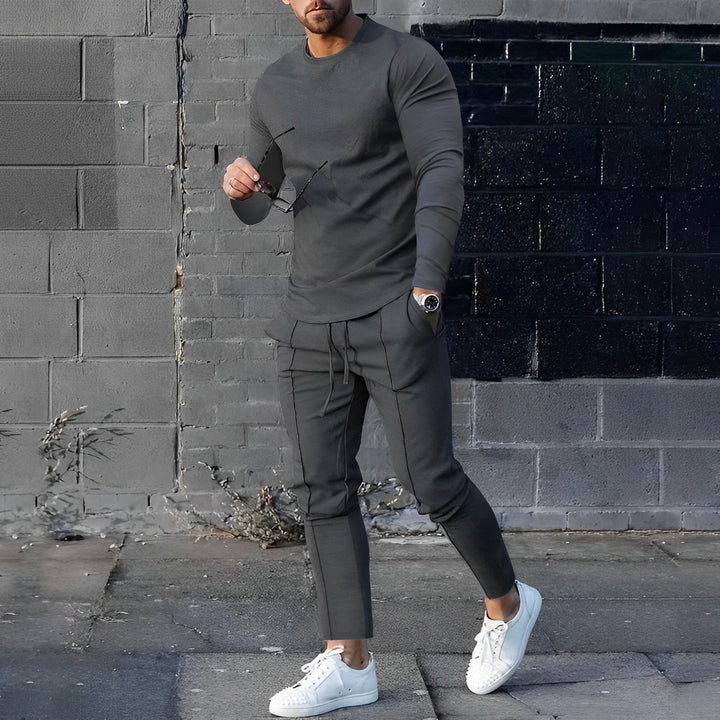 Full-length view of men's coordinating set in black with elasticated waistband trousers