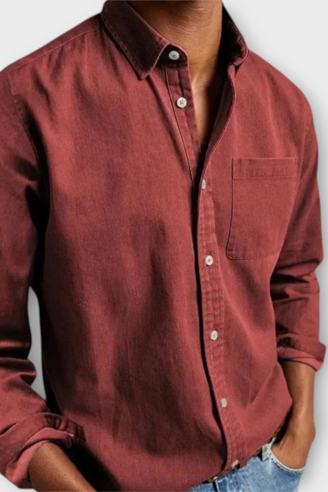 Men's mid-blue denim shirt with structured collar and button-up front, timeless casual staple