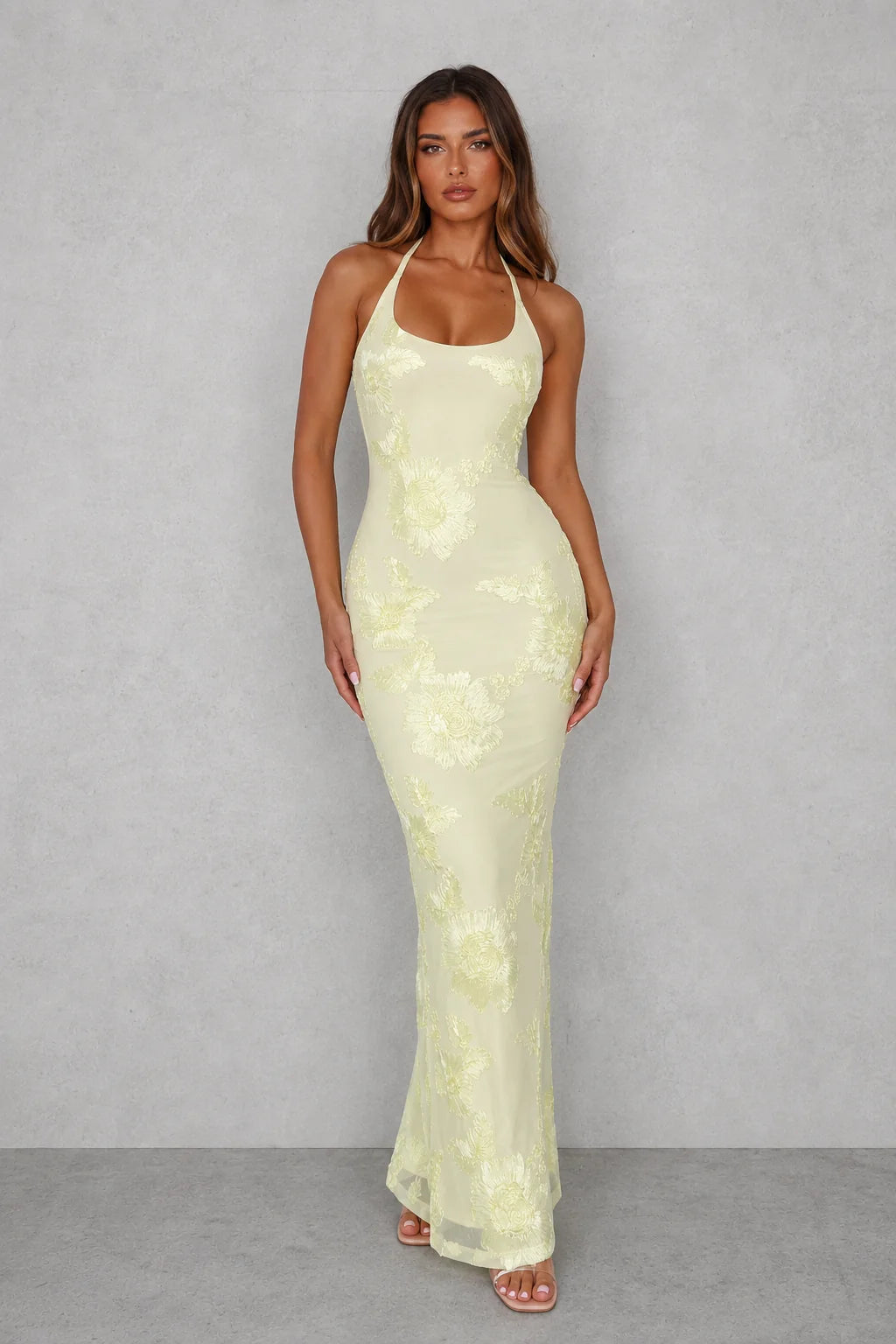 Halter backless maxi dress in pale lemon with floral embroidered detail and high back split for formal occasions