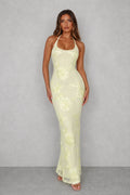 Halter backless maxi dress in pale lemon with floral embroidered detail and high back split for formal occasions
